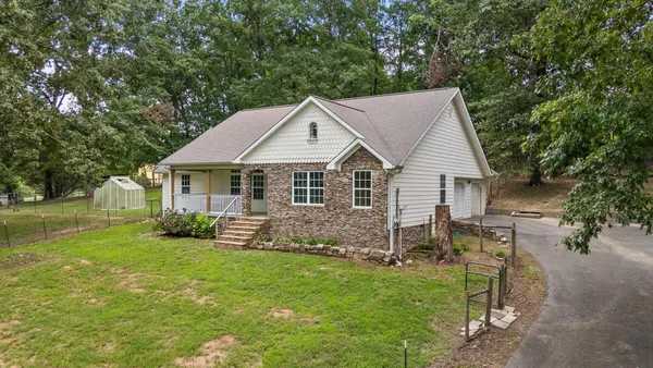 a aerial view of a house with a yard table and chairs