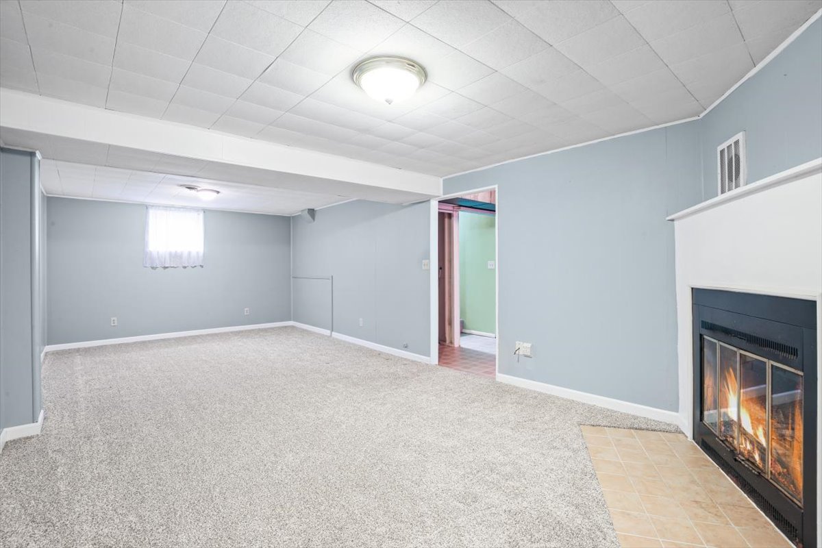 1513 Gates Drive Rantoul, IL 61866 - Photo 28 of 37 a view of an empty room with a fireplace and a window