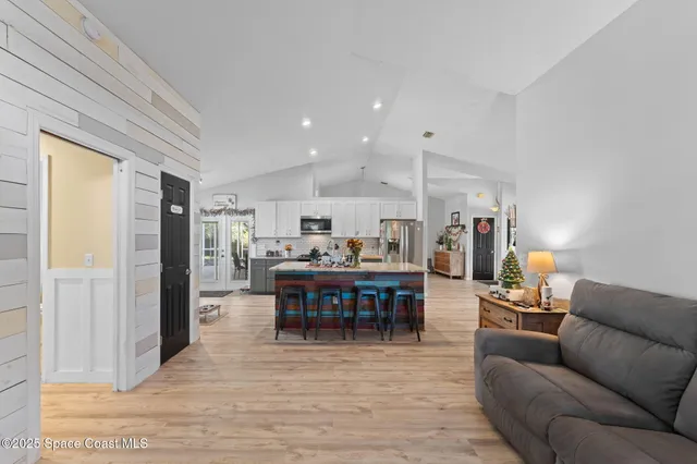 a living room with furniture a dining table and a piano table