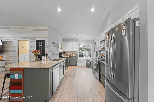 a kitchen with counter top space and stainless steel appliances