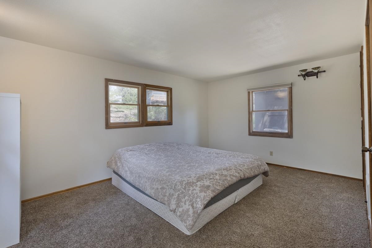 2030 Old Mammoth Road Mammoth Lakes, CA 93546 - Photo 21 of 46 a bed sitting in a bedroom next to a window