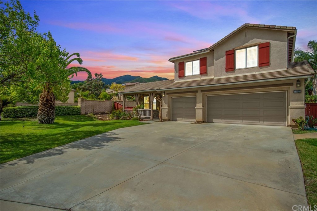 23537 Cantara Road Corona, CA 92883 - Photo 11 of 60 front view of a house with a yard