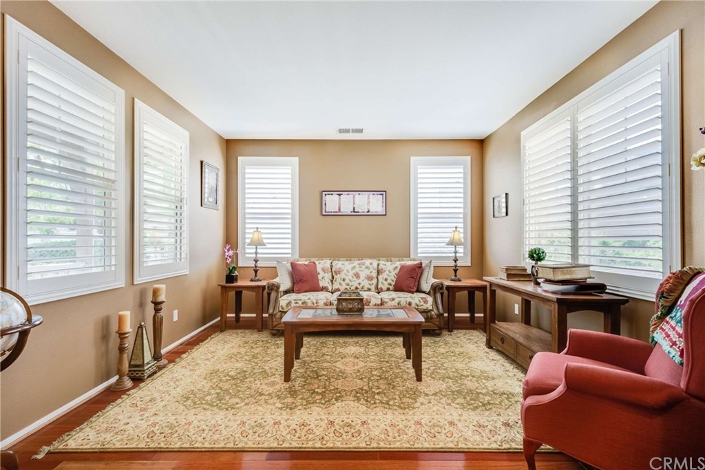 23537 Cantara Road Corona, CA 92883 - Photo 15 of 60 a living room with furniture and a large window