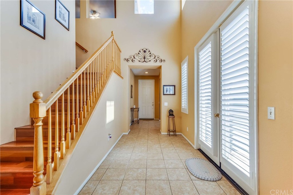 23537 Cantara Road Corona, CA 92883 - Photo 18 of 60 a view of a hallway with windows and stairs