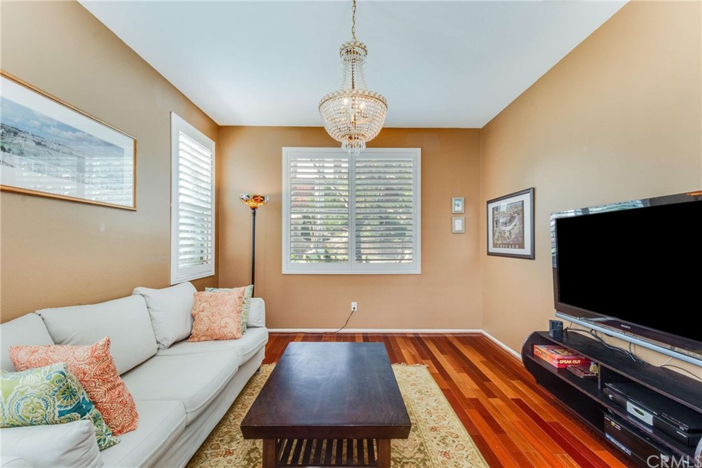23537 Cantara Road Corona, CA 92883 - Photo 20 of 60 a living room with furniture and a flat screen tv