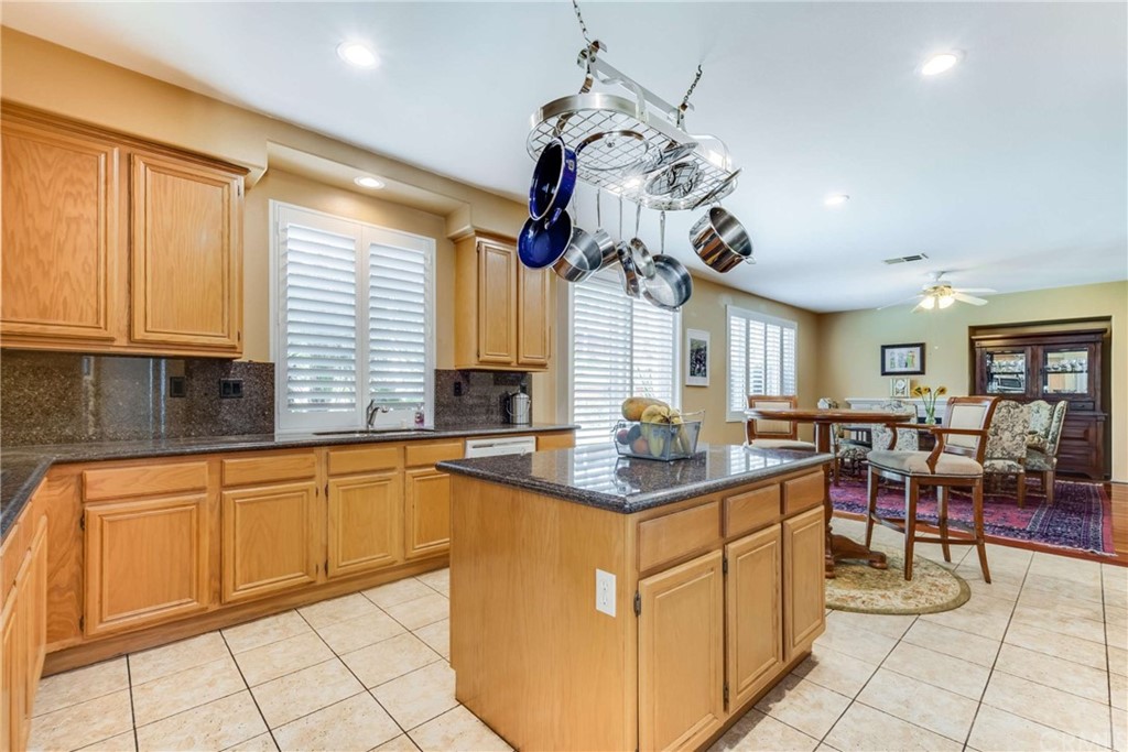 23537 Cantara Road Corona, CA 92883 - Photo 21 of 60 a kitchen with stainless steel appliances granite countertop breakfast area sink and cabinets