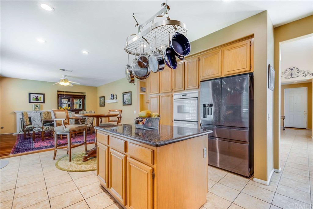 23537 Cantara Road Corona, CA 92883 - Photo 22 of 60 a kitchen with stainless steel appliances granite countertop a stove refrigerator and cabinets