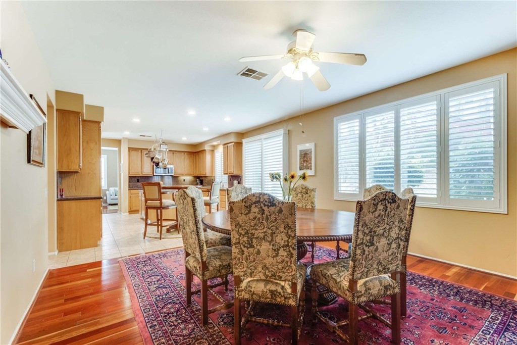 23537 Cantara Road Corona, CA 92883 - Photo 27 of 60 a view of a dining room with furniture and chandelier
