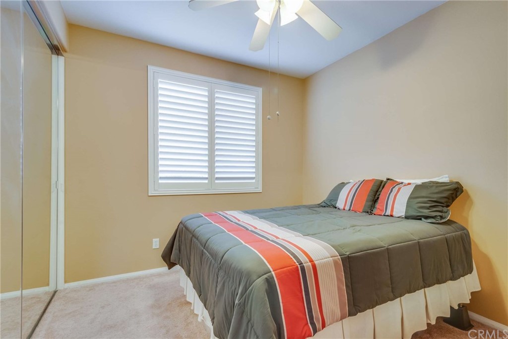 23537 Cantara Road Corona, CA 92883 - Photo 29 of 60 a bedroom with a bed and a window