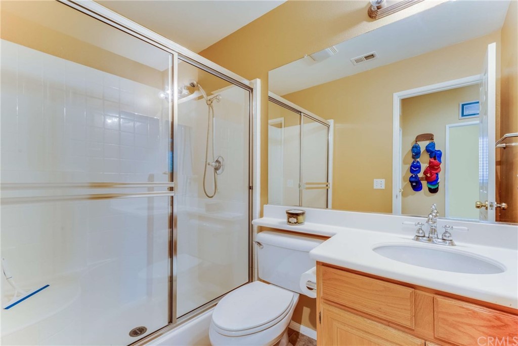 23537 Cantara Road Corona, CA 92883 - Photo 32 of 60 a bathroom with a sink a toilet and shower