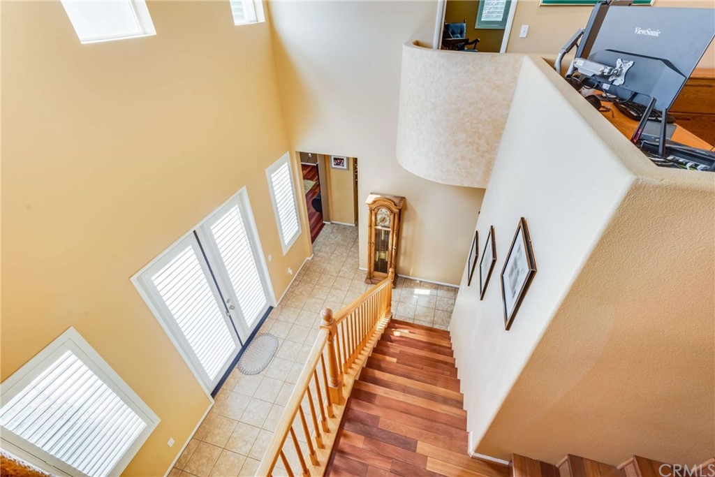 23537 Cantara Road Corona, CA 92883 - Photo 33 of 60 a view of a hallway with wooden floor and stairs
