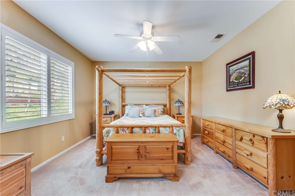 23537 Cantara Road Corona, CA 92883 - Photo 36 of 60 a bedroom with a bed and a window