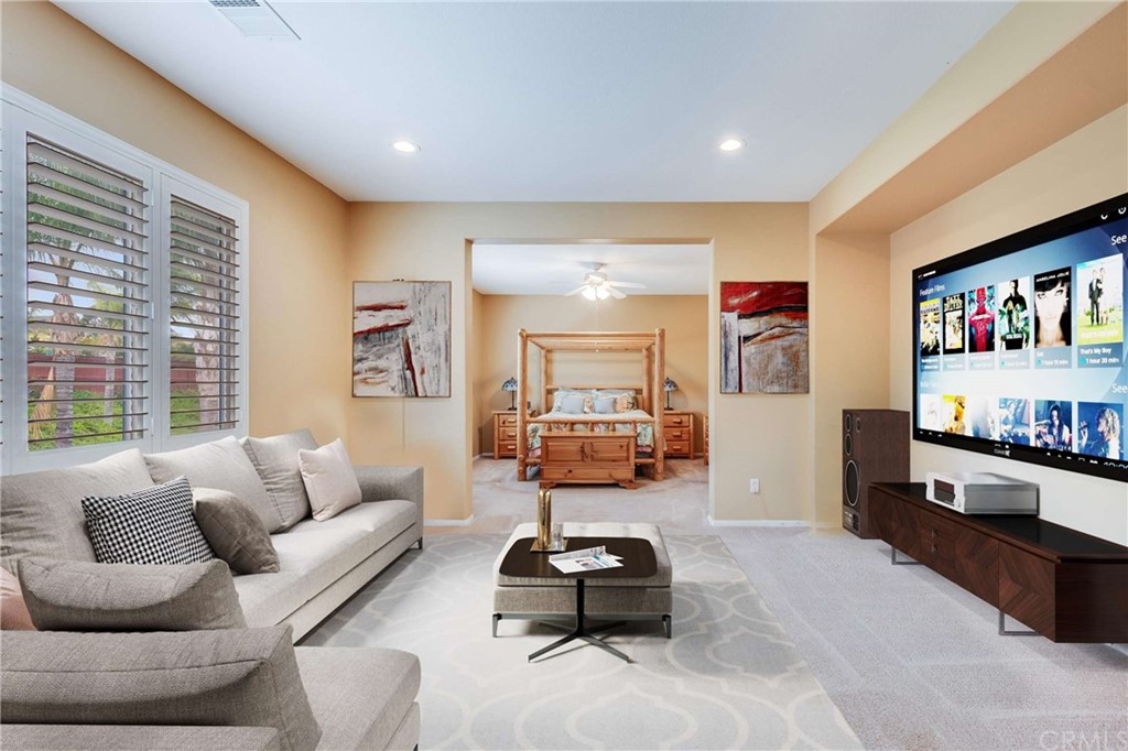 23537 Cantara Road Corona, CA 92883 - Photo 42 of 60 a living room with furniture and a book shelf