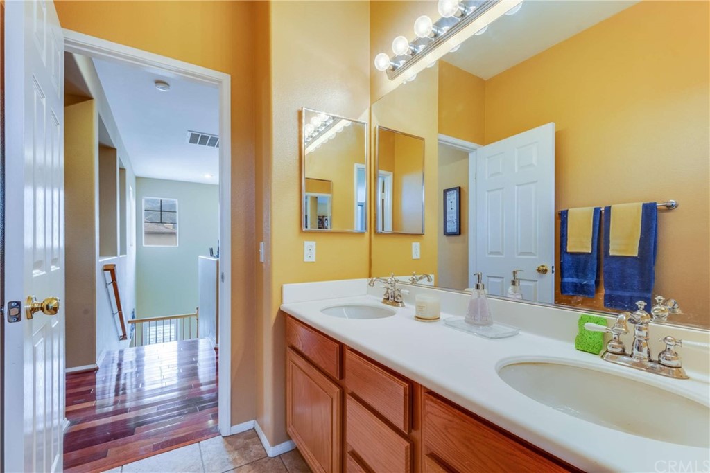 23537 Cantara Road Corona, CA 92883 - Photo 48 of 60 a bathroom with a sink and a mirror