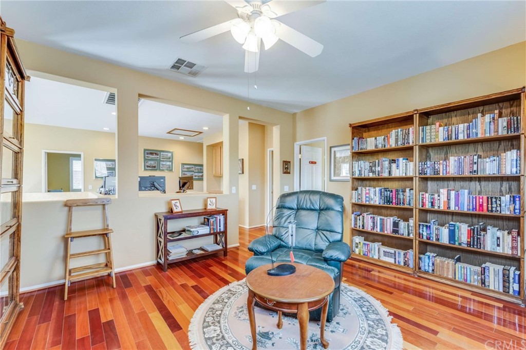 23537 Cantara Road Corona, CA 92883 - Photo 50 of 60 a bedroom with furniture and a book shelf