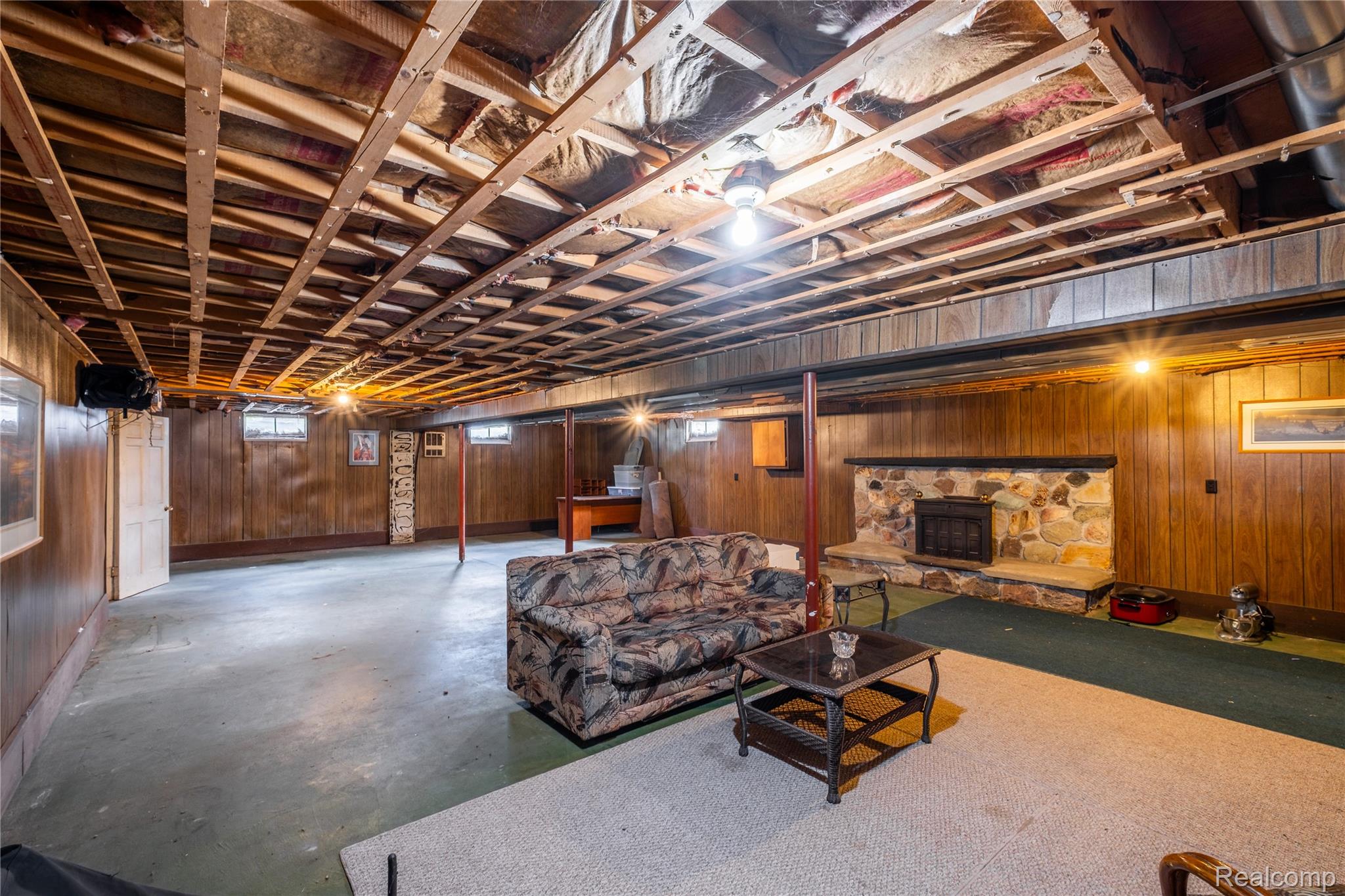 11430 Silver Lake Road Byron, MI 48418 - Photo 20 of 32 Finished below grade area with wood walls and a stone fireplace