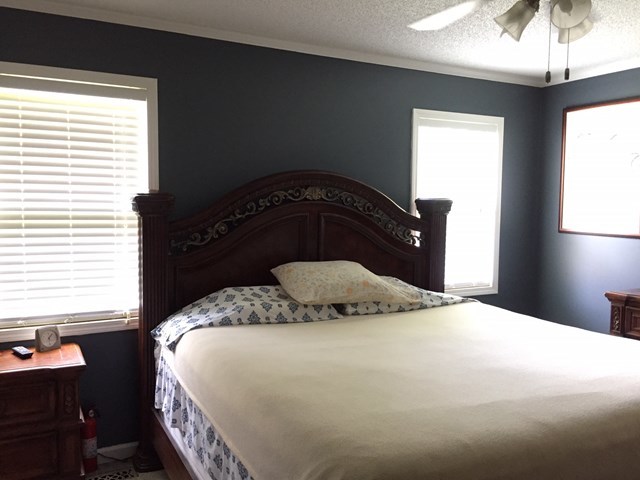 513 Music Row, Unit 9 Forsyth, GA 31029 - Photo 8 of 19 a bedroom with a bed and a chandelier