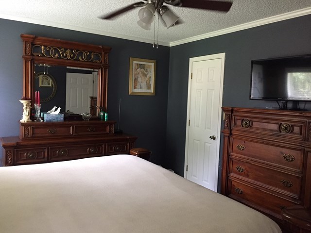 513 Music Row, Unit 9 Forsyth, GA 31029 - Photo 9 of 19 a bedroom with a bed and a dresser