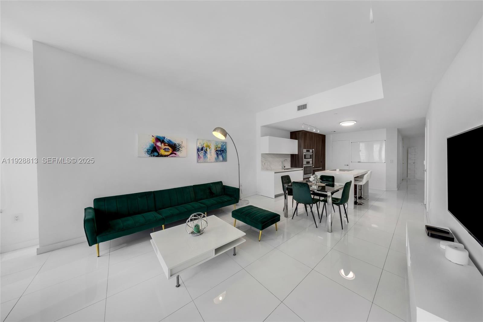 851 Northeast 1st Avenue, Unit 1700 Miami, FL 33132 - Photo 15 of 30 a living room with furniture and a flat screen tv