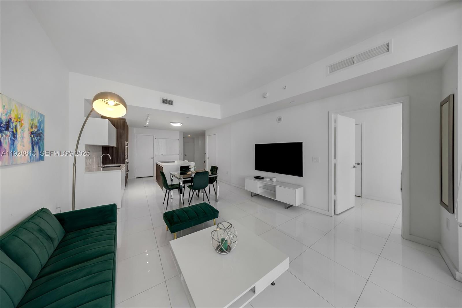 851 Northeast 1st Avenue, Unit 1700 Miami, FL 33132 - Photo 16 of 30 a living room with furniture and a flat screen tv