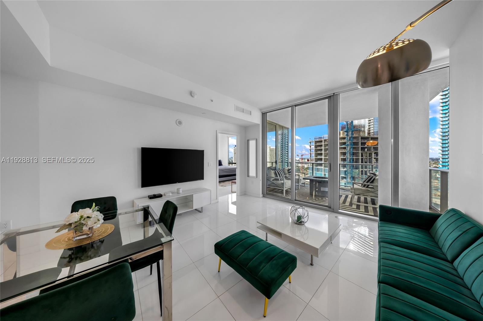851 Northeast 1st Avenue, Unit 1700 Miami, FL 33132 - Photo 17 of 30 a living room with furniture and a flat screen tv