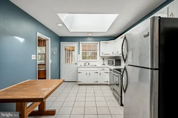 a kitchen with stainless steel appliances granite countertop a sink and stove top oven