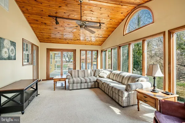 a bathroom with a granite countertop toilet sink and mirror