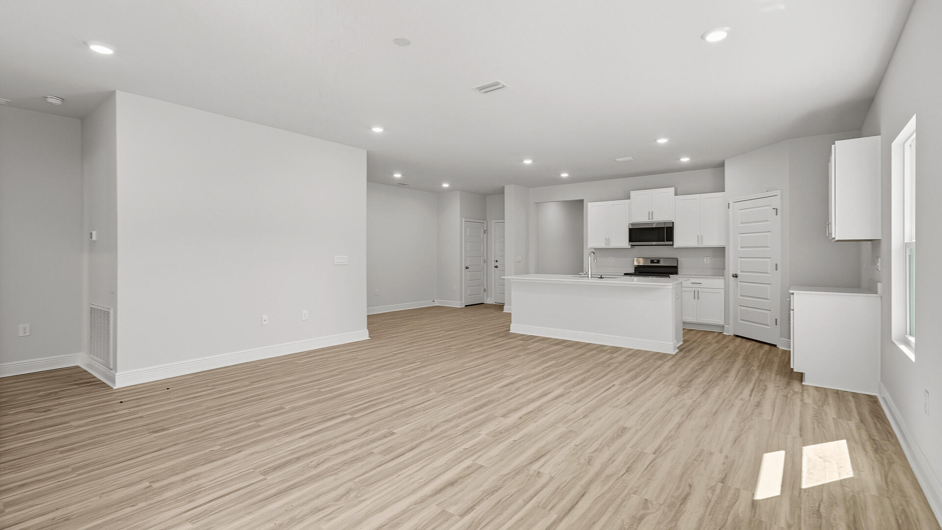 2075 Wiregrass Street Navarre, FL 32566 - Photo 9 of 29 a view of a kitchen with wooden floor and electronic appliances