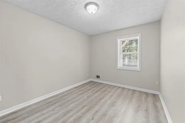 a bathroom with a granite countertop sink a toilet and a mirror