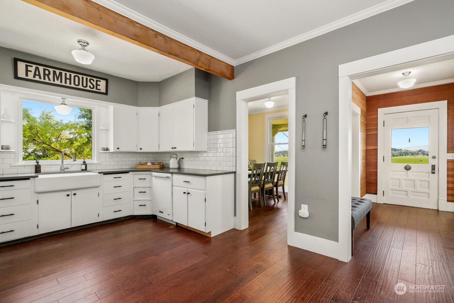 9120 Lowell Larimer Road Everett, WA 98208 - Photo 17 of 40 a kitchen with wooden floors and white cabinets
