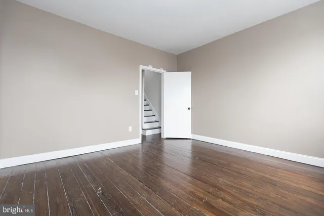 a view of an empty room and wooden floor