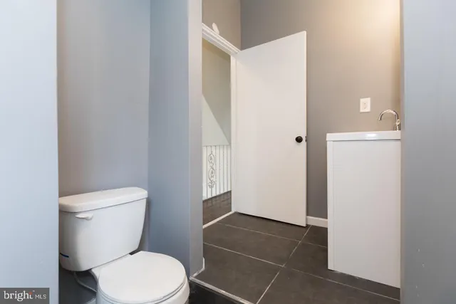 a white toilet sitting next to a bathroom sink