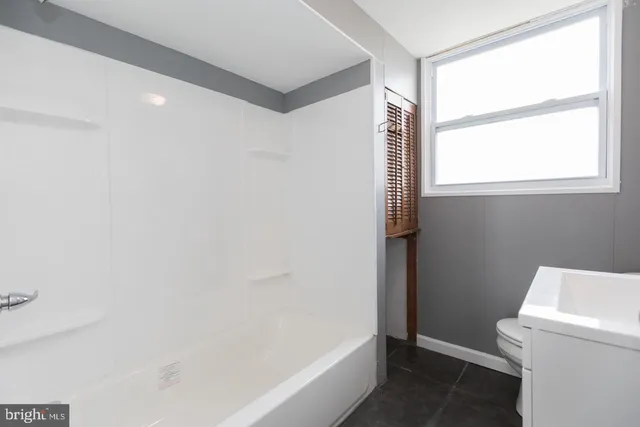 a bathroom with a bathtub and a toilet