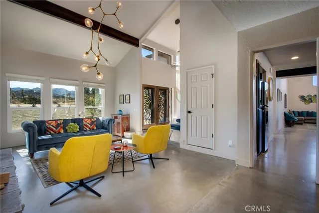 a dining hall with stainless steel appliances granite countertop a stove and a dining table