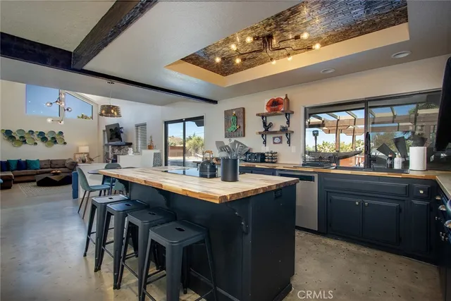a kitchen with a sink cabinets and wooden floor