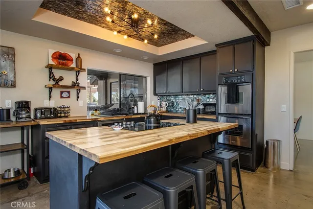 a kitchen with kitchen island a sink stove and refrigerator