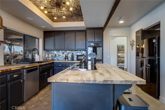 a kitchen with stainless steel appliances granite countertop a sink stove and cabinets