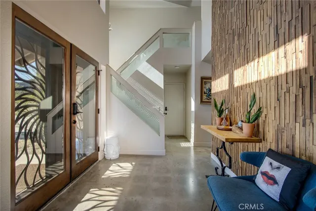 a large bedroom with bed and flat tv with wooden floor