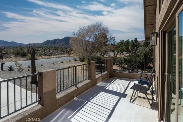 a view of a balcony with wooden benches