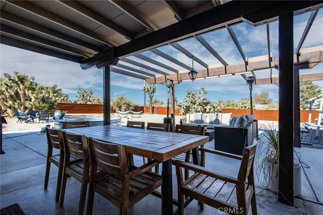 a view of a patio with a table and chairs