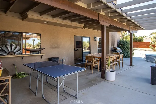 a view of a chairs and table in a patio
