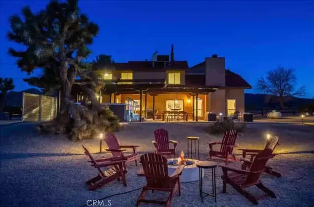 a living room with furniture and a lamp
