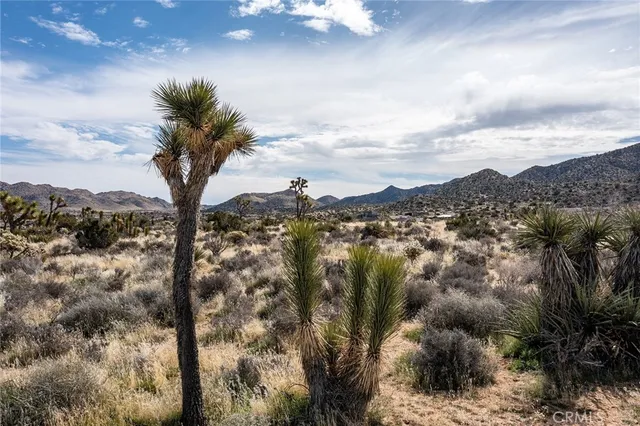 an aerial view of a house with outdoor seating