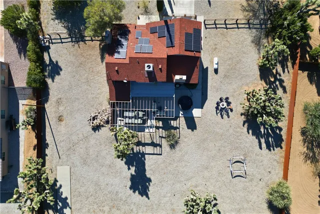 a view of a palm trees front of house with a yard