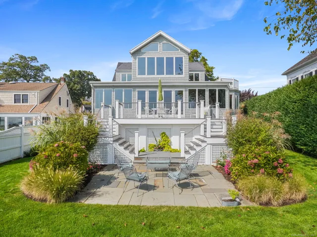 a view of a house with a yard and potted plants