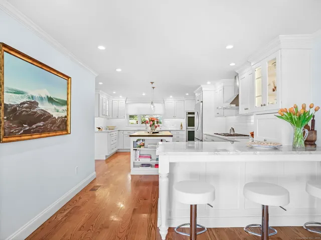 a view of kitchen with granite countertop lots of clutter and stainless steel appliances
