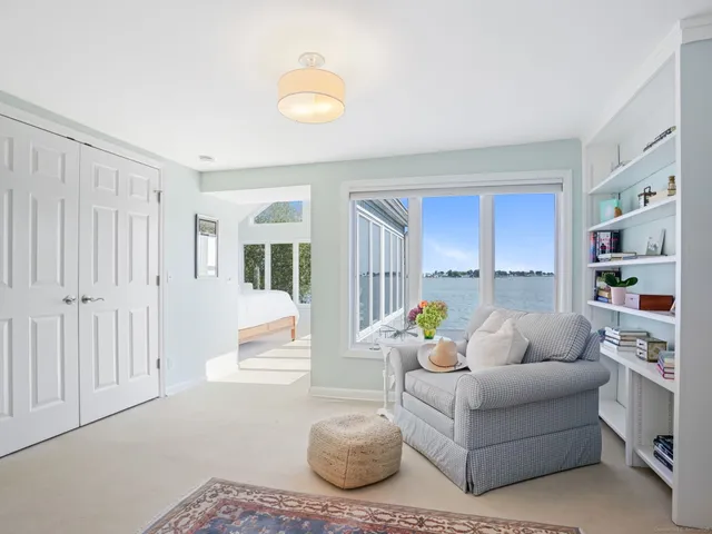 a bedroom with furniture and large windows