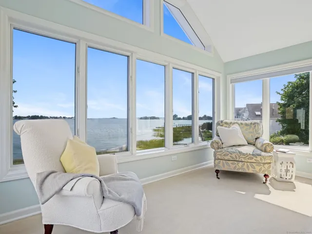 a bedroom with furniture and large windows