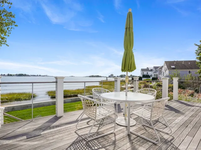 an aerial view of residential houses with outdoor space and swimming pool