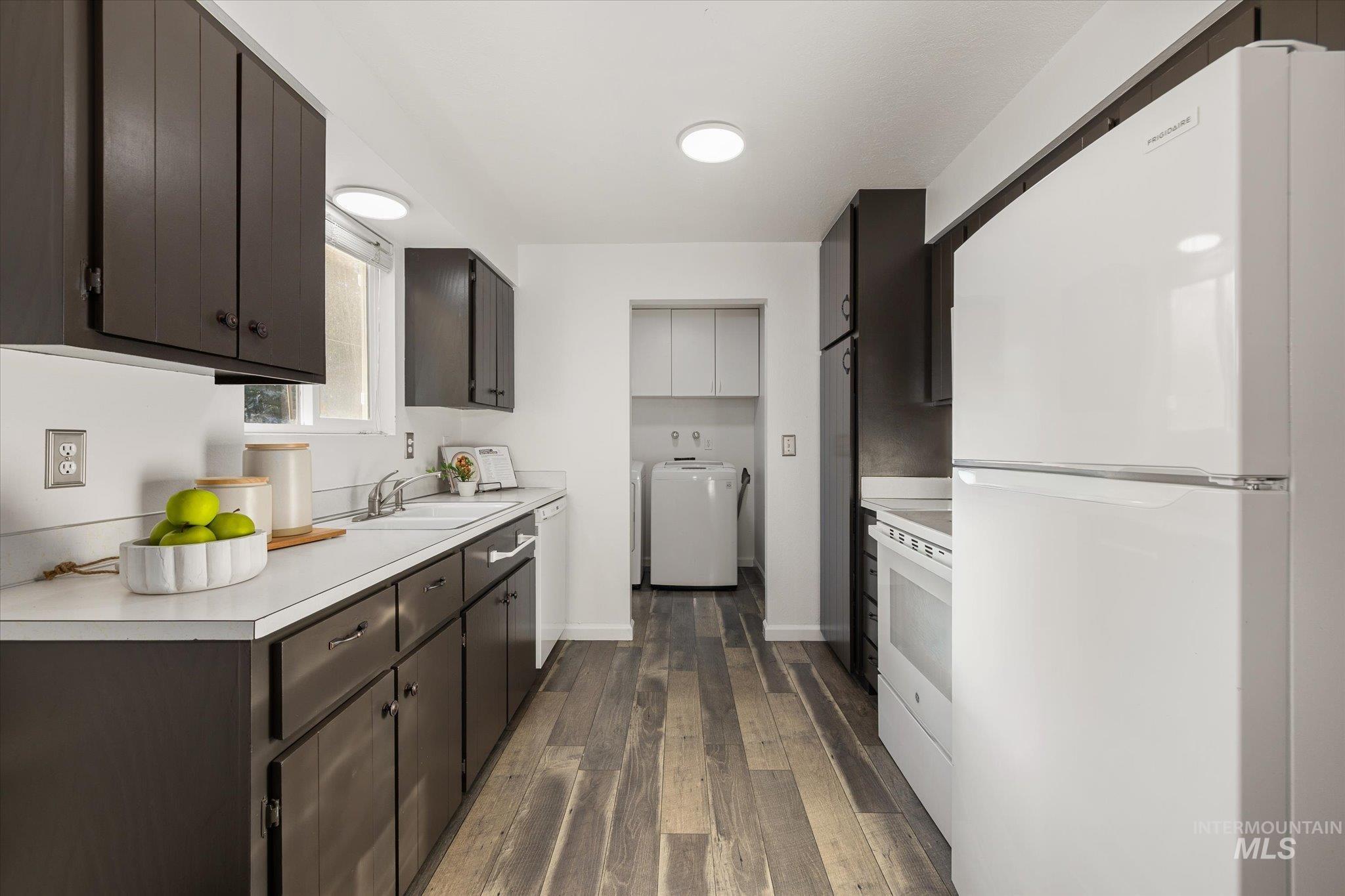 2302 Pendleton Street Boise, ID 83705 - Photo 12 of 35 Kitchen featuring dark wood-finish cabinetry, white countertops, and wood-finish flooring